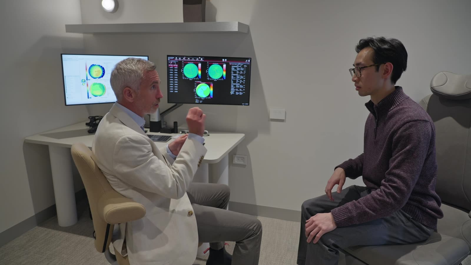 Dr Richard Barry talking a patient through his corneal scans